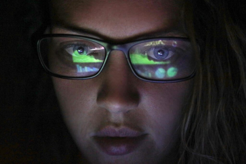 A close up picture of a woman watching coding